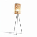 Rattan floor lamp with three legs and a woven design for indoor use